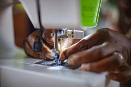 A person skillfully operating a sewing machine to create a garment.