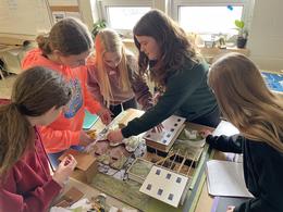 Five girls building sustainable community diorama on desk